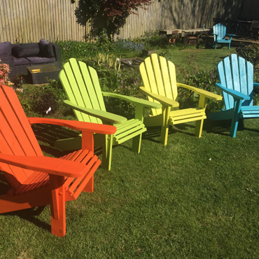 A slection of painted Adirondack chairs